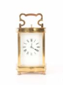 A French-style brass carriage clock with a serpentine corniche, repeating action and chiming on a go