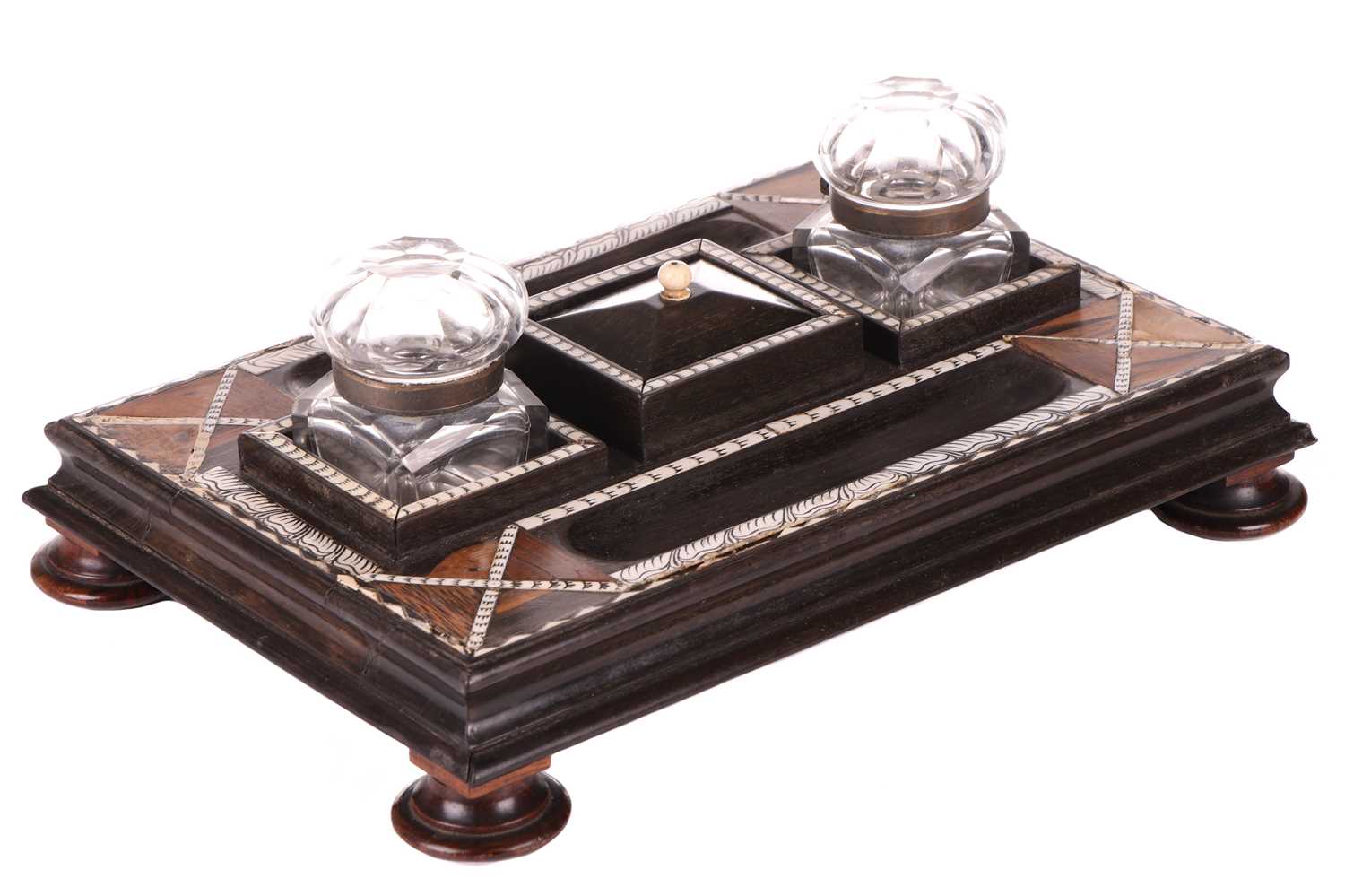 A Ceylonese ebony desk stand with calamander, coconut palm, and rosewood parquetry within pen-worked