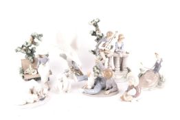 A collection of eight Lladro figurines comprising Sunday in the park, the serenade, a boy with dog, 