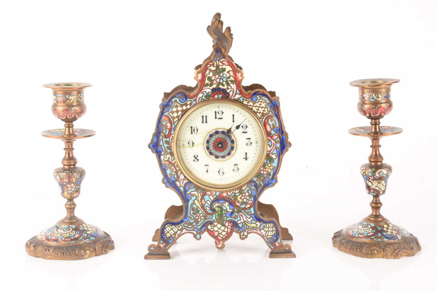 A late 19th-century French champléve enamel mantle clock with matching candlesticks, clock measures 