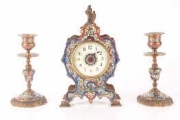 A late 19th-century French champléve enamel mantle clock with matching candlesticks, clock measures 