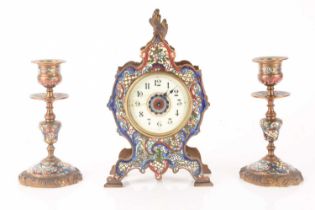 A late 19th-century French champléve enamel mantle clock with matching candlesticks, clock