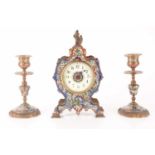 A late 19th-century French champléve enamel mantle clock with matching candlesticks, clock measures 