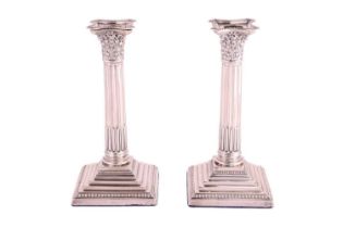 A pair of silver Corinthian column candlesticks, by the Atkin Brothers, Sheffield 1923, with beaded 