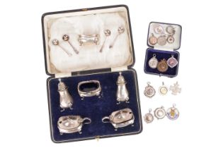 A boxed set of silver pepperettes, mustards with spoons and salts with blue glass liners, hallmarked