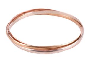 A 9ct tri-colour gold Russian bangle, with three interlocking round court-shaped bangles, the inner 