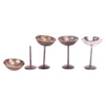 A set of four champagne coupes, shallow circular bowls supported on a straight stem and round foot, 