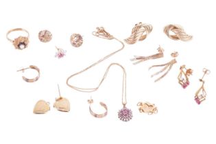 A collection of jewellery items including a 9ct gold floral ring, a pair of 9ct gold twist earrings,