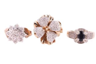Three gem-set rings, comprising a 9ct yellow gold diamond-set flower head ring, size O, a floral clu