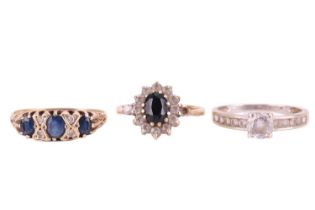 Three gem-set rings comprising a sapphire and diamond-set half-hoop ring in 9ct yellow gold, size T,