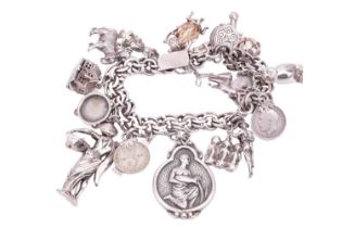 A silver charm bracelet with eighteen assorted charms and fobs including an owl, a stag, a country m