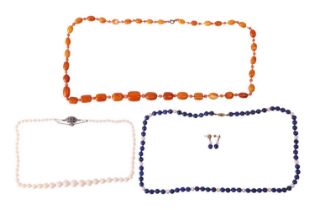 Three beaded necklaces and a pair of matching earrings; to include an amber bead necklace with a ser