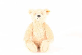 A blonde Steiff bear made by Steiff as a replica of the 1920s classic design, stitched nose, fully