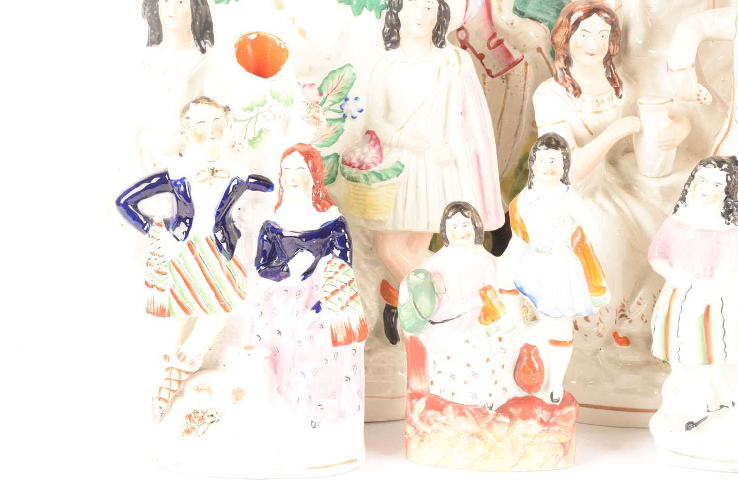 A large collection of Staffordshire and Staffordshire style couple figures comprising a couple on th - Image 2 of 6