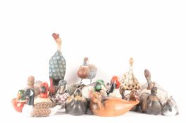A large collection of duck figures of varying forms, materials, ages, and makes, 16 total, the large