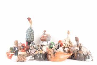 A large collection of duck figures of varying forms, materials, ages, and makes, 16 total, the