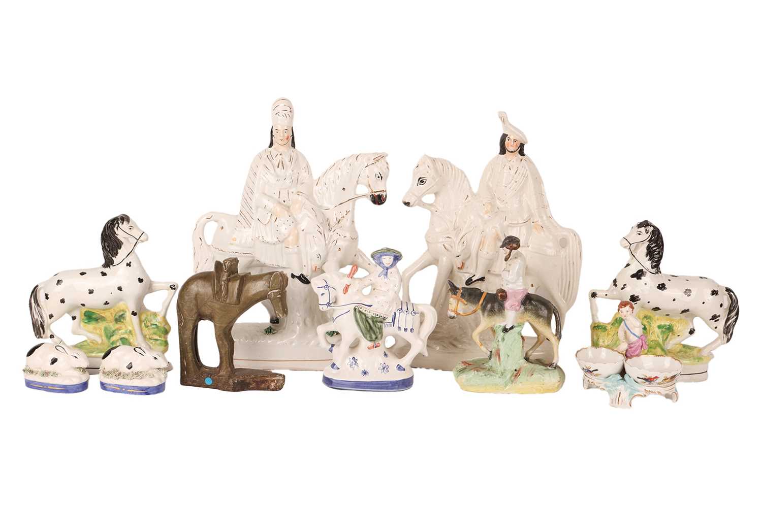 A collection of Staffordshire and in the style of Staffordshire figurines to include a large pair on