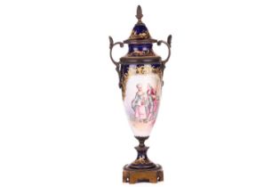 A 19th-century Sevres porcelain vase and cover, decorated with a courting couple, a chateau and lake