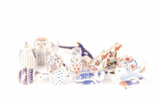 A collection of Royal Crown Derby paperweights comprising an Imari pattern Dolphin and a Fox, both