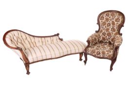 A 19th-century mahogany framed upholstered day-bed, alongside an armchair with floral patterned upho