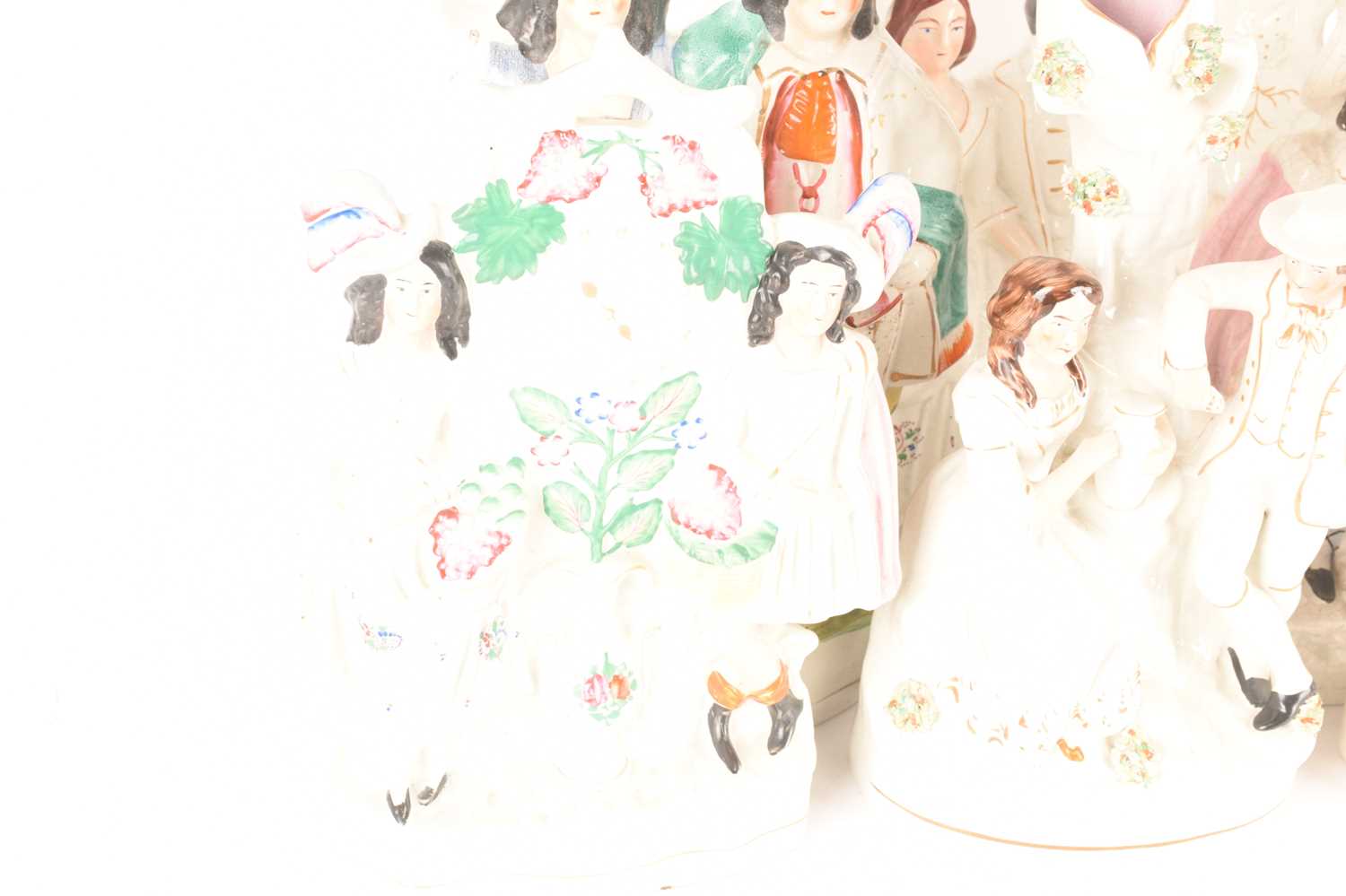 A large collection of Staffordshire and Staffordshire style couple figures comprising a couple on th - Image 4 of 6