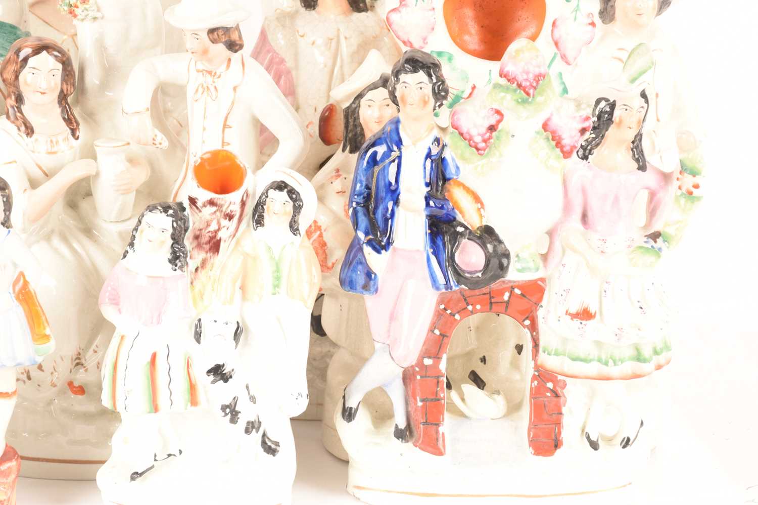 A large collection of Staffordshire and Staffordshire style couple figures comprising a couple on th - Image 3 of 6