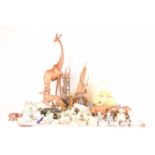 A large collection of decorative art figures comprising a large group of safari animals, a wooden go