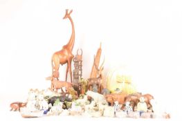 A large collection of decorative art figures comprising a large group of safari animals, a wooden go