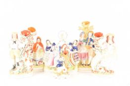 A group of Staffordshire and Staffordshire-style spill vases comprising Little Red Riding Hood, a gi