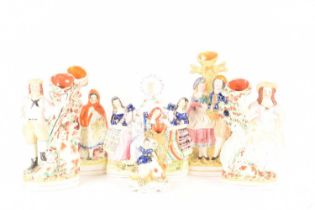A group of Staffordshire and Staffordshire-style spill vases comprising Little Red Riding Hood, a