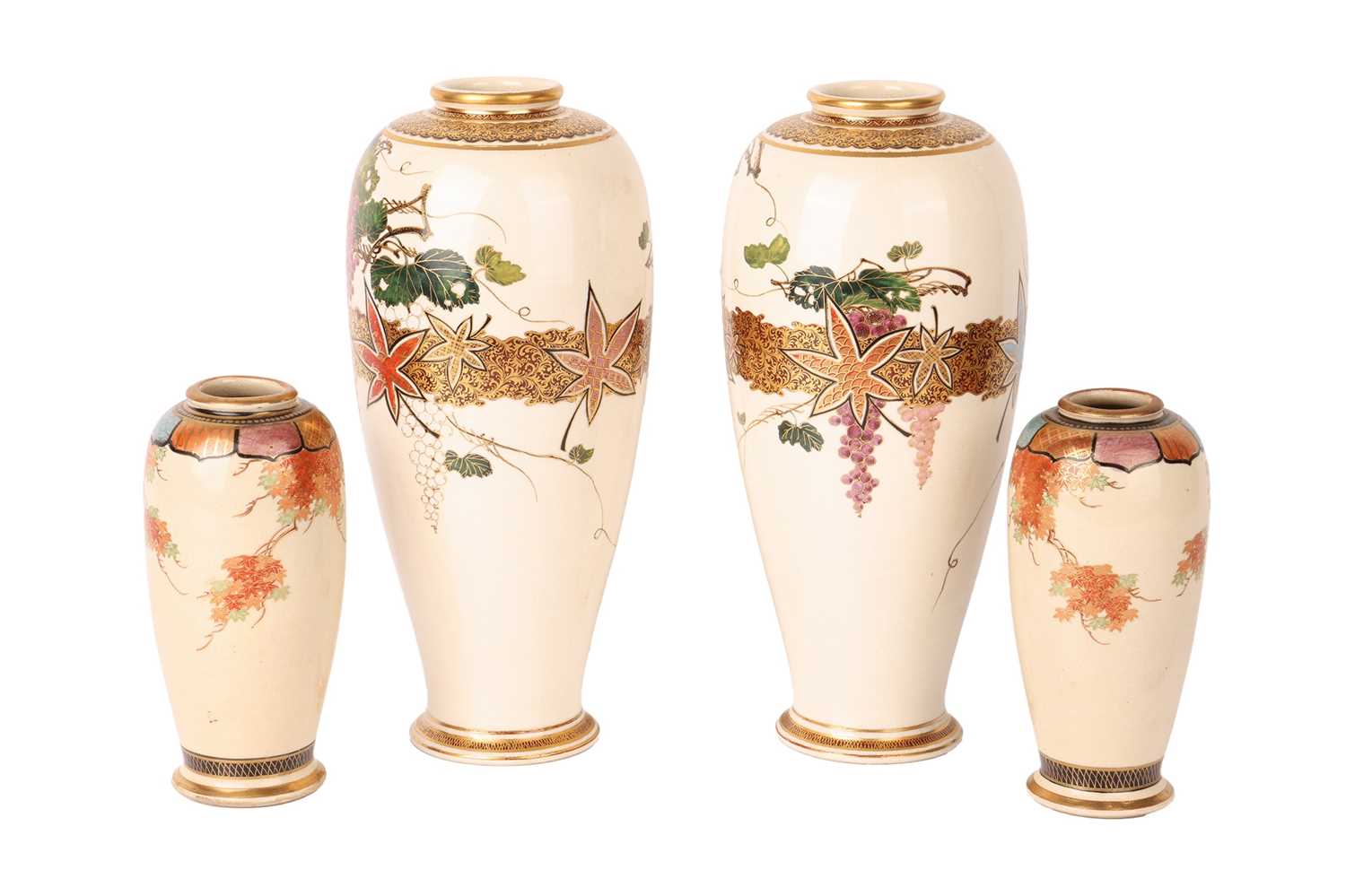 Two graduated pairs of Meiji period Japanese Satsuma vases, decorated with a wisteria motif, the lar