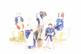 A collection of Staffordshire and Staffordshire-style figures comprising a Prince Albert figure, a Q