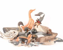 A large collection of duck figures of varying forms, materials, ages, and makes, 15 total, the