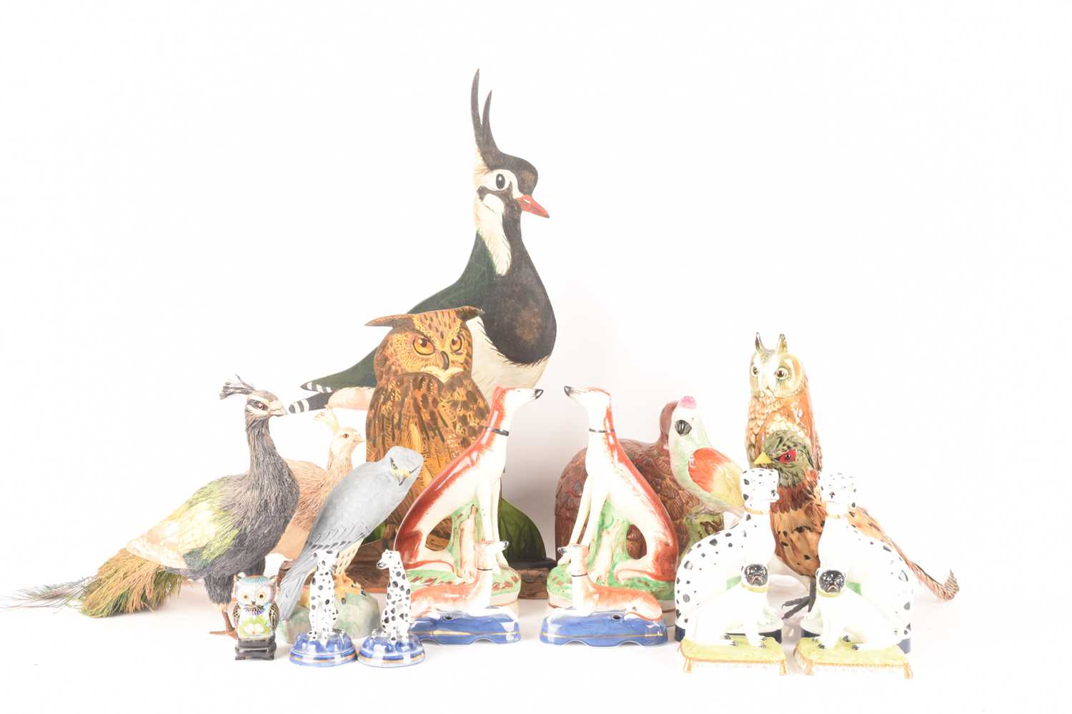 A pair of Staffordshire whippet hound mantle figurines, alongside a further four pairs of dog figuri
