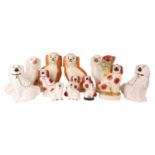 A collection of five pairs of the classic Staffordshire and Staffordshire style King Charles dog fig