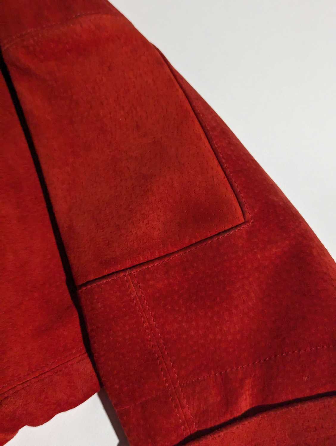 Jean Muir - an oversized bright red suede leather jacket with side pockets, size UK8; a black rayon  - Image 9 of 17