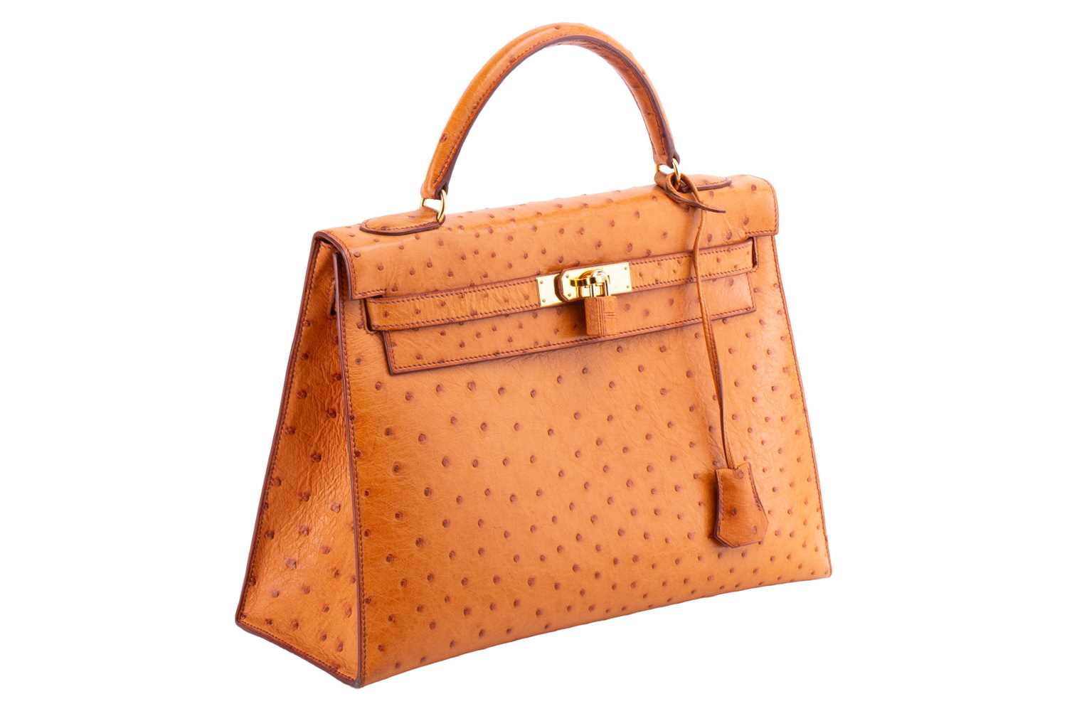 Hermès - a Kelly Sellier 32 in gold ostrich leather, 1999, tapered structured body with gold-tone ha