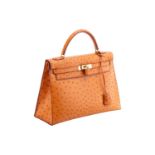 Hermès - a Kelly Sellier 32 in gold ostrich leather, 1999, tapered structured body with gold-tone ha