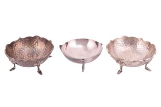 A pair of Arts and Crafts silver bonbon dishes, on four feet, with planished finish, hallmarks for