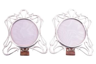 A pair of silver Art Nouveau photo frames, of abstract design, 17.5 x 16cm, the circular aperture