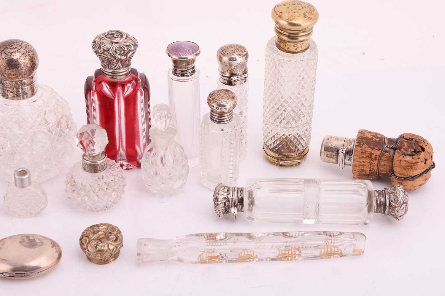 A collection of cut glass scent bottles, many with silver mounts, one featuring an enamel portrait c - Image 3 of 5