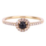 A Whitby jet and diamond halo ring in 18ct yellow gold, consisting of a round jet cabochon within a 