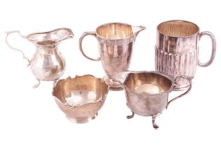 A small collection of 20th-century silver, comprising two cream jugs, a milk jug, a beaker and a