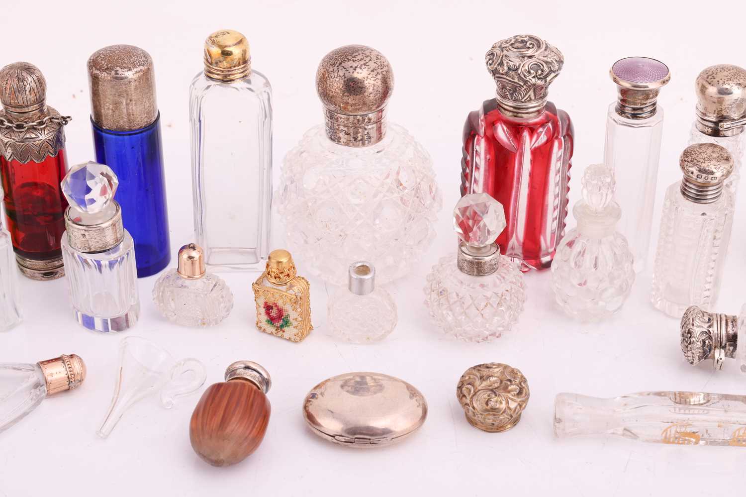 A collection of cut glass scent bottles, many with silver mounts, one featuring an enamel portrait c - Image 4 of 5