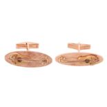 A pair of Baroque guitar cufflinks, elongated oval panels with a cross-hatched finish ground, applie