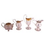 Three silver cream jugs and a milk jug; to include a George III stemmed cream jug with repoussé work