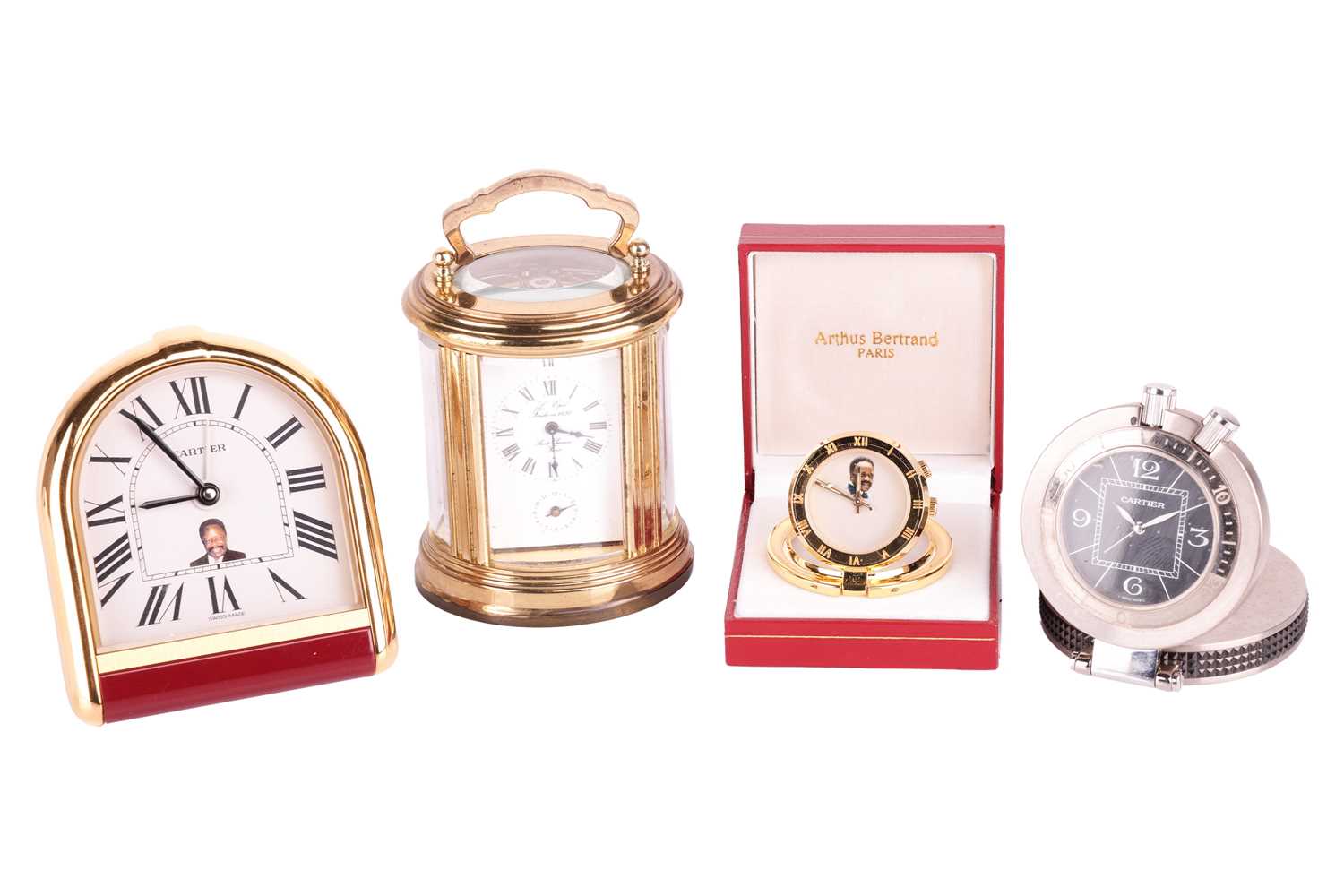 A collection of four travel clocks. Featuring two Cartier clocks, an Arthus Bertrand Paris and an L'