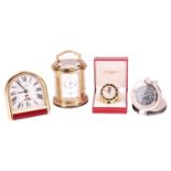 A collection of four travel clocks. Featuring two Cartier clocks, an Arthus Bertrand Paris and an L'