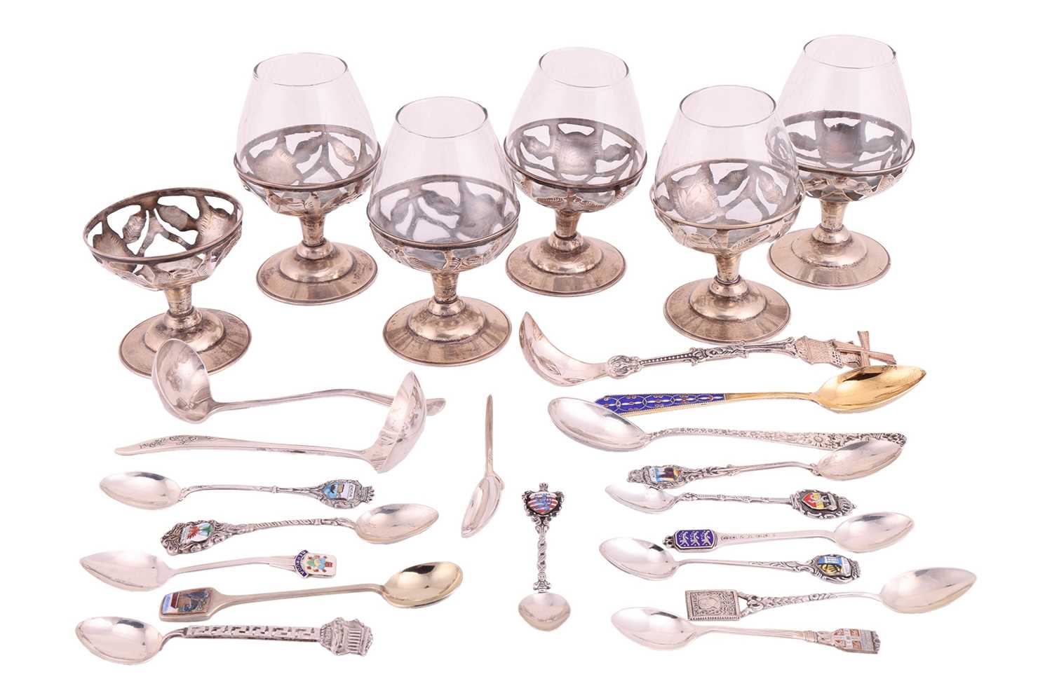 A small group of assorted souvenir spoons with enamel finials; and a set of six cordial glasses in w