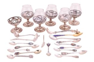 A small group of assorted souvenir spoons with enamel finials; and a set of six cordial glasses in